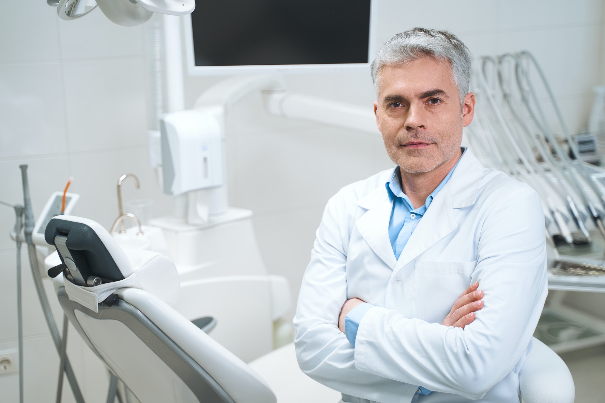 Mature dentist in his office stock photo