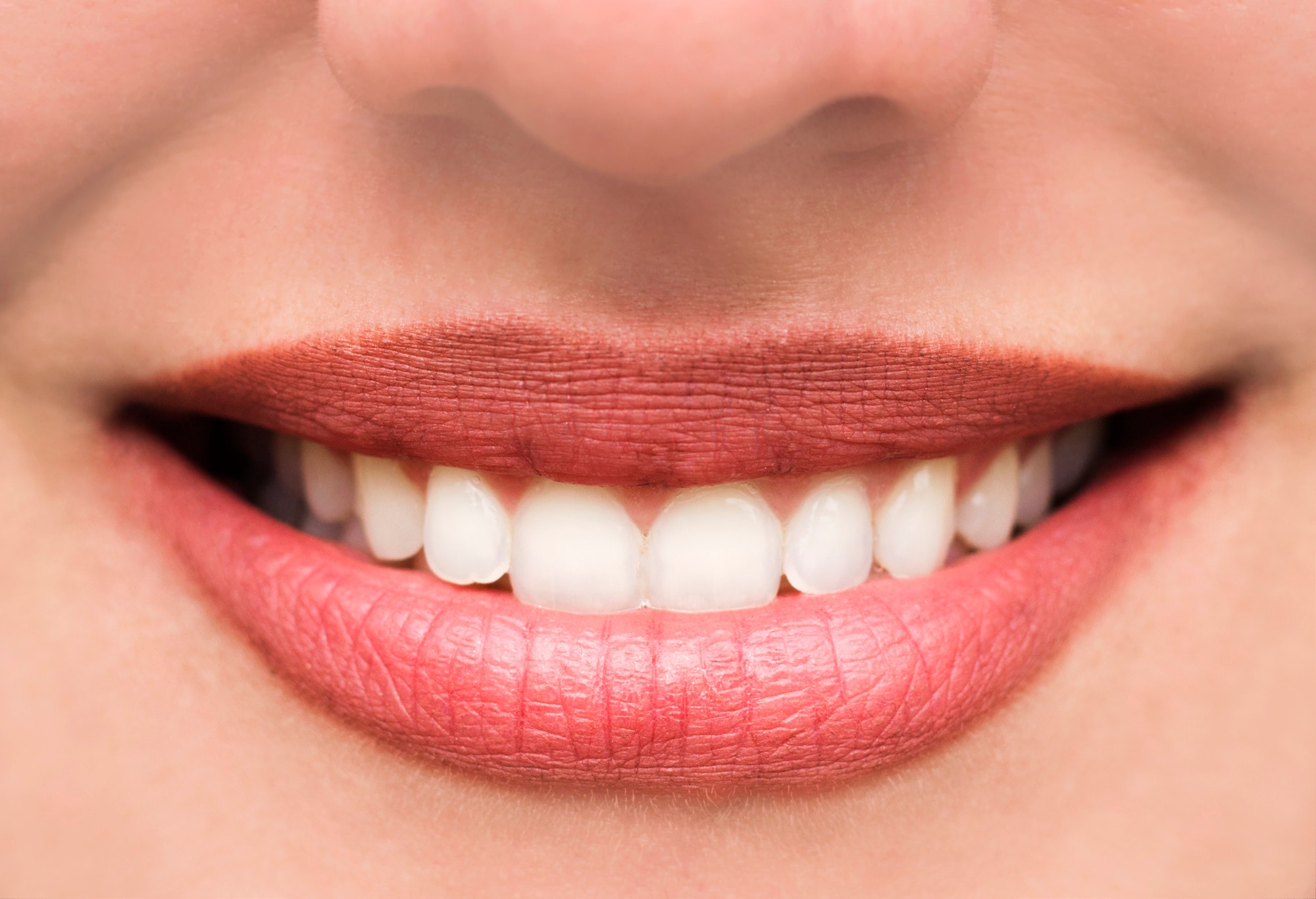 Woman's lips and teeth smile, close up